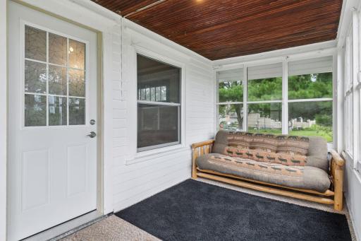 The porch has a wood ceiling and there is an insulated steel door to enter the home.