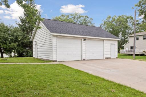 The detached garage with cement driveway.
