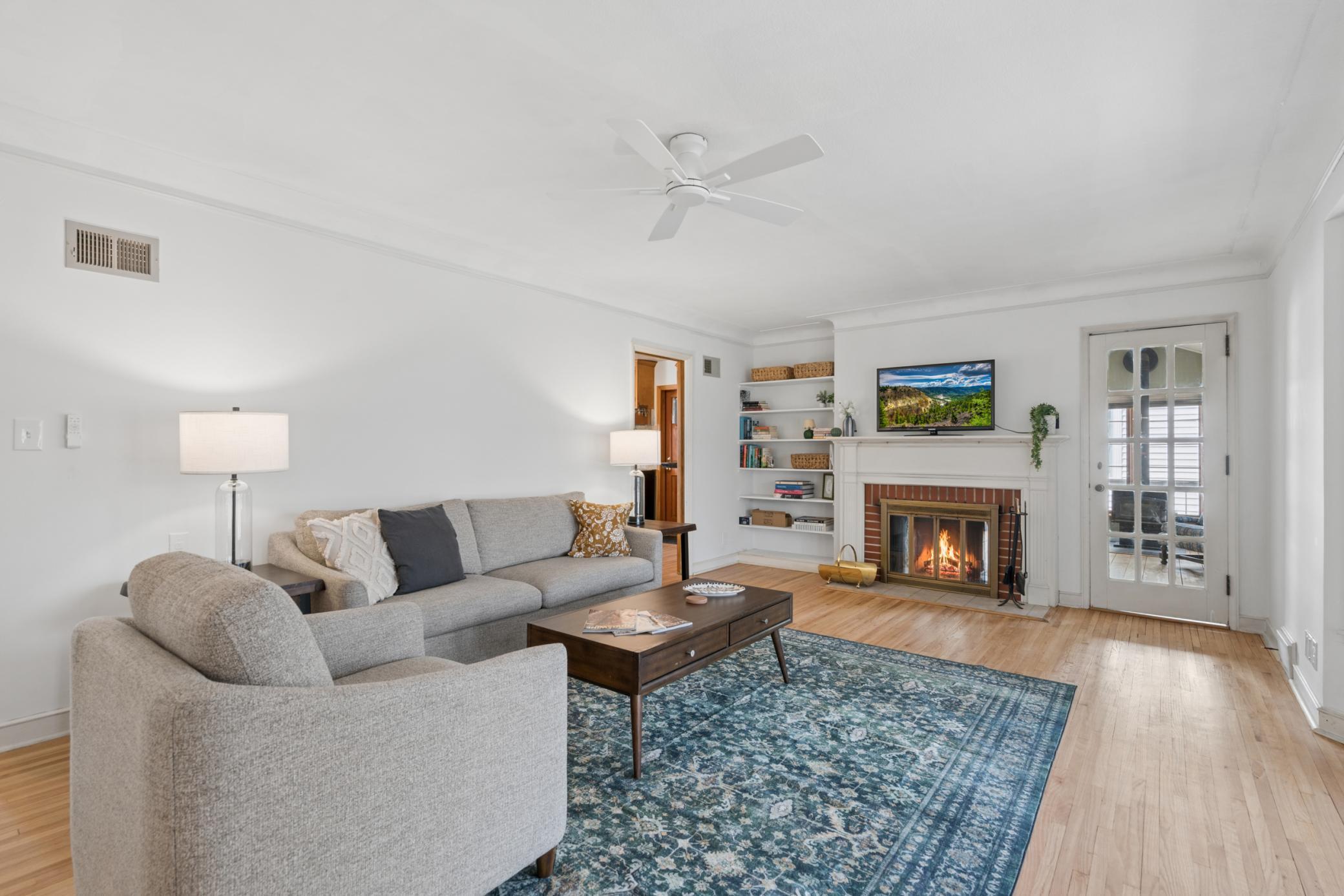 Spacious main living area with built-ins, abundant natural light, and a functional layout that flows seamlessly to indoor and outdoor living spaces.