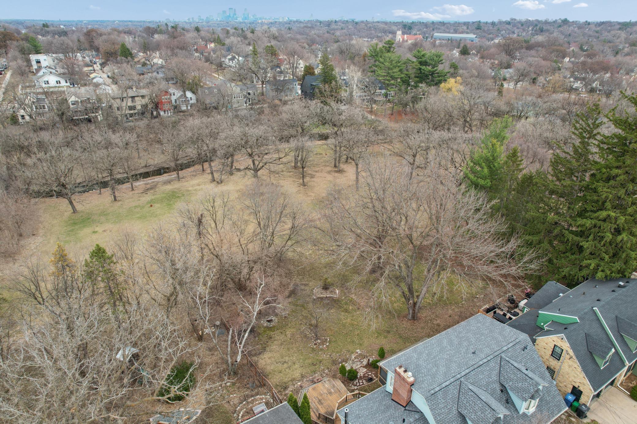 Private, oversized .24 acre lot backing directly to Minnehaha Creek with mature trees and natural landscape