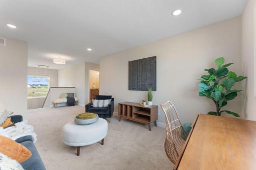 Loft is at the top of the stairs. Laundry room on one side. Hallway with bedrooms the other way.