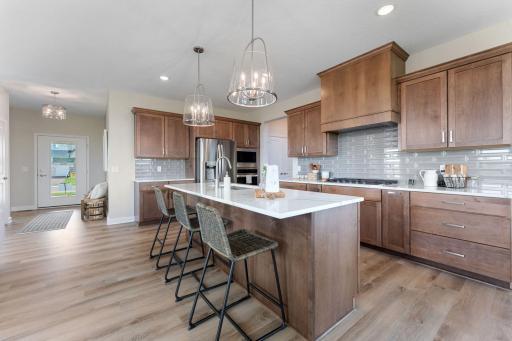 Gourmet kitchen with gas cook-top, wood hood (externally vented), built-in wall oven and microwave