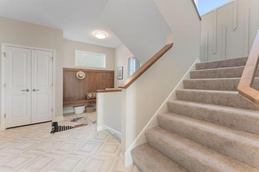 Custom boot bench in the mudroom with storage under and hooks above