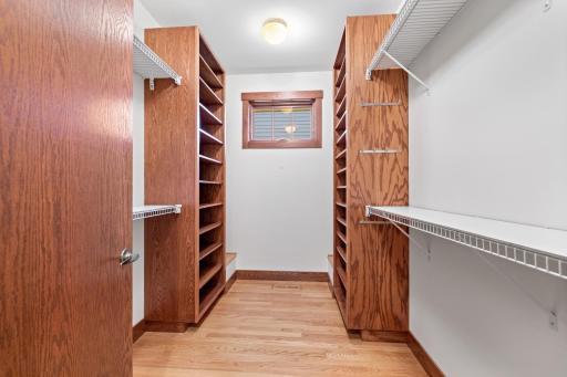 Elegantly organized primary closet with custom design