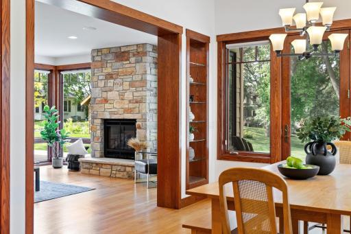 Expansive Marvin windows bathe the dining room in natural light, with serene views of the backyard