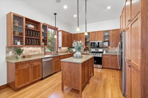 Vaulted ceilings elevate the kitchen and dining spaces, filling them with light and architectural drama
