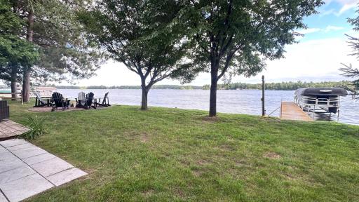 Backyard with firepit, deck and patio. Dock stays with property.