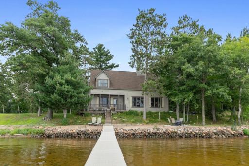 Experience lakefront living in this charming home nestled amongst towering pines. This two-story home offers the perfect blend of rustic charm & features a sandy beach and effortless lake access. New architectural roof, and gutter guards, 2021.