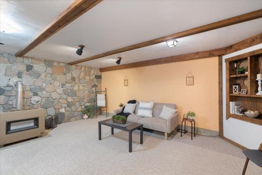 Lower Level Recreation Room With Gas Heater & Stone Wall