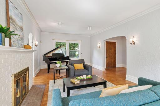 Period light fixtures adorn the formal living room, which is generously sized