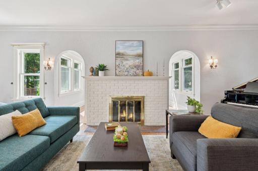 Twin archways lead to the luminous first floor sunroom