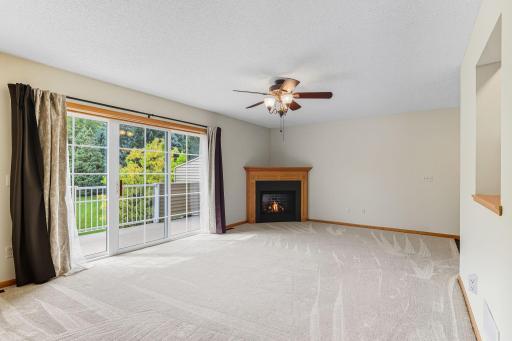 2714 Brockman Ct, Northfield - large living room area with plush new carpet less than 1 yr old offers a serene view of trees and greenery.