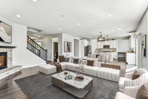 The open-concept main level features a stunning modern kitchen in this Pulte built Riverton floorplan.