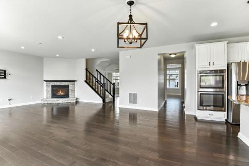 The wood laminate floor color has a beautiful grey undertone that comes out in cooler light while soft white light gives it a warmer tone.