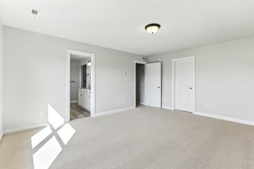 The primary suite is complete with a large walk-in closet and private bath.