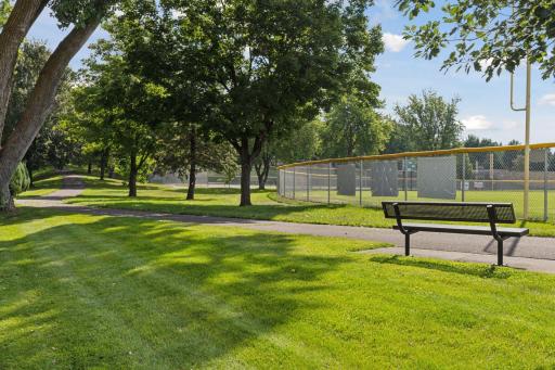 Paved paths connect to Northside city park with ballfields, picnic shelter, playground, tennis courts, lighted skating rink with warming house and sliding hill!