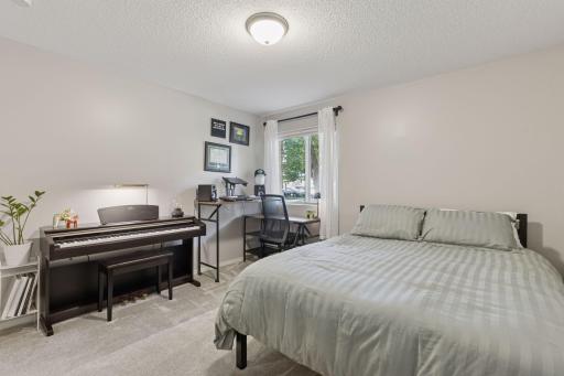 Spacious guest bedroom/office with large closet and plush neutral carpet