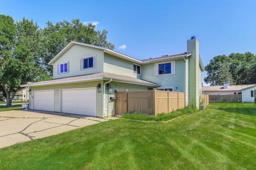 Corner-unit townhome with a rare 2-car garage and a large side yard.
