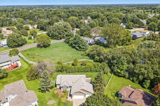 The home backs up to not only city-owned land, but a trail system that traverses through the neighborhood. And the hedges at the fence are large enough to provide ample privacy for you.