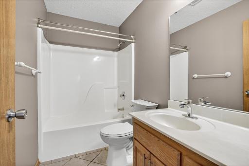 This main level full bath features tile floors and a tub/shower surround.