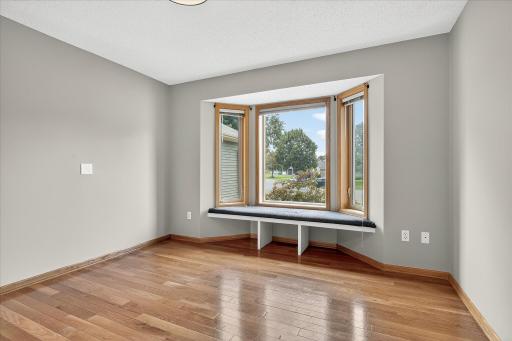 This is the 2nd bedroom on the main level, which features neutral paint on the walls, 3/4" solid oak flooring and large windows.