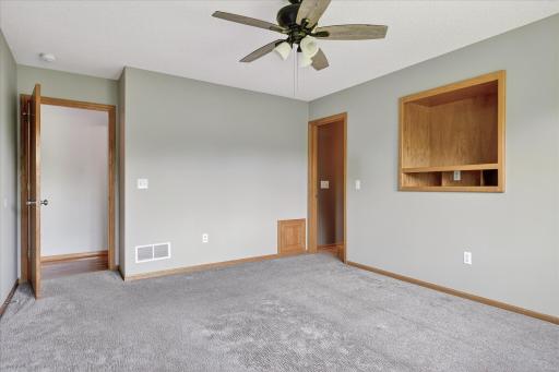 The door on the left goes out to the Living Room, and the one on the right leads to the private primary full bath.