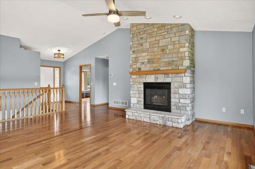 The main level living spaces are vaulted and the living room features three distinct comfort features - a WiFi enabled digital thermostat ( new in 2019), a ceiling fan and a gas fireplace with a floor-to-ceiling stacked stone surround