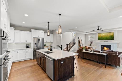 Timeless custom white cabinetry enhances the charm of the hardwood floors.
