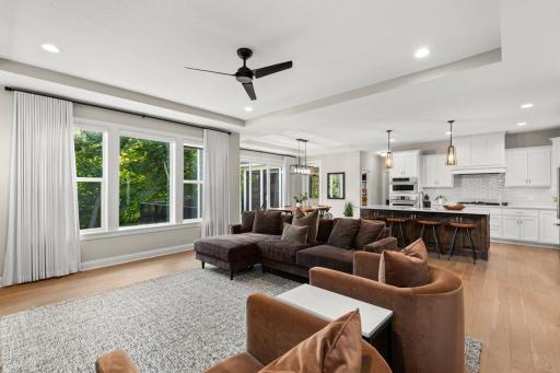 Walls of windows showcase serene backyard views and flood the home with natural light