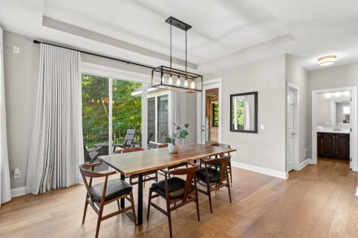 The informal dining space offers serene views overlooking the backyard