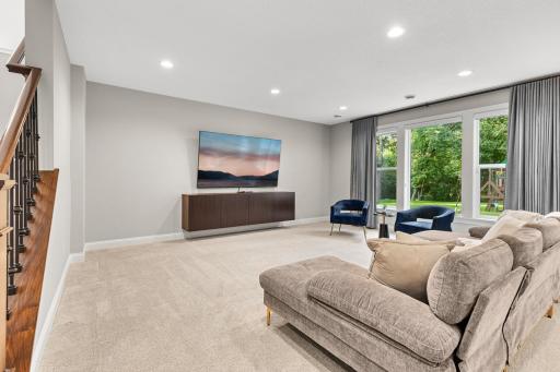 The lower level boasts an open, spacious design ideal for entertaining or everyday living