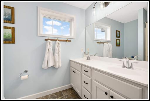 A full bathroom with shower/tub combo serves the upper level