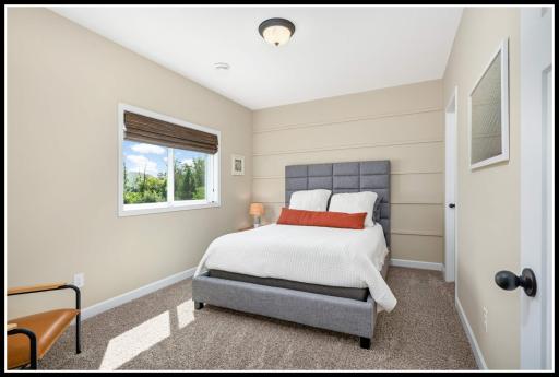 Fifth bedroom on the lower level looks out to backyard wetlands