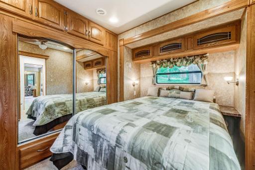 The master bedroom has a slide out and features a large closet and comfortable bed.