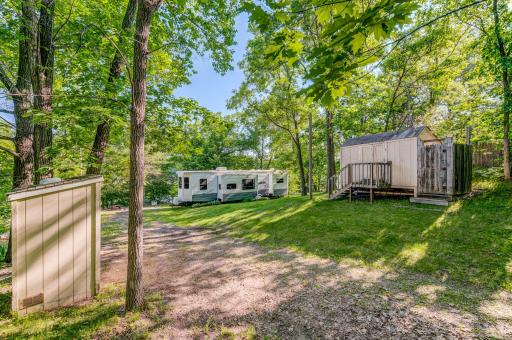 Great view of the Park model, shed, and yard of this property.