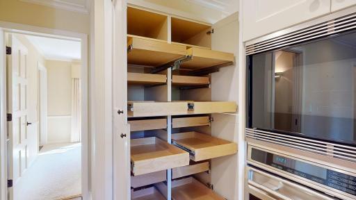 Beautifully organized roll-out pantry designed for easy access