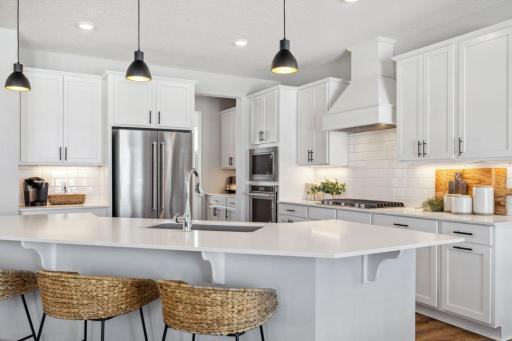 Island comfortably seats 5. Photo of a model home, color & options will vary.