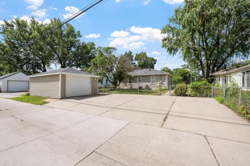 Detached 2 car garage with additional storage and multiple off-street parking spaces in the driveway.