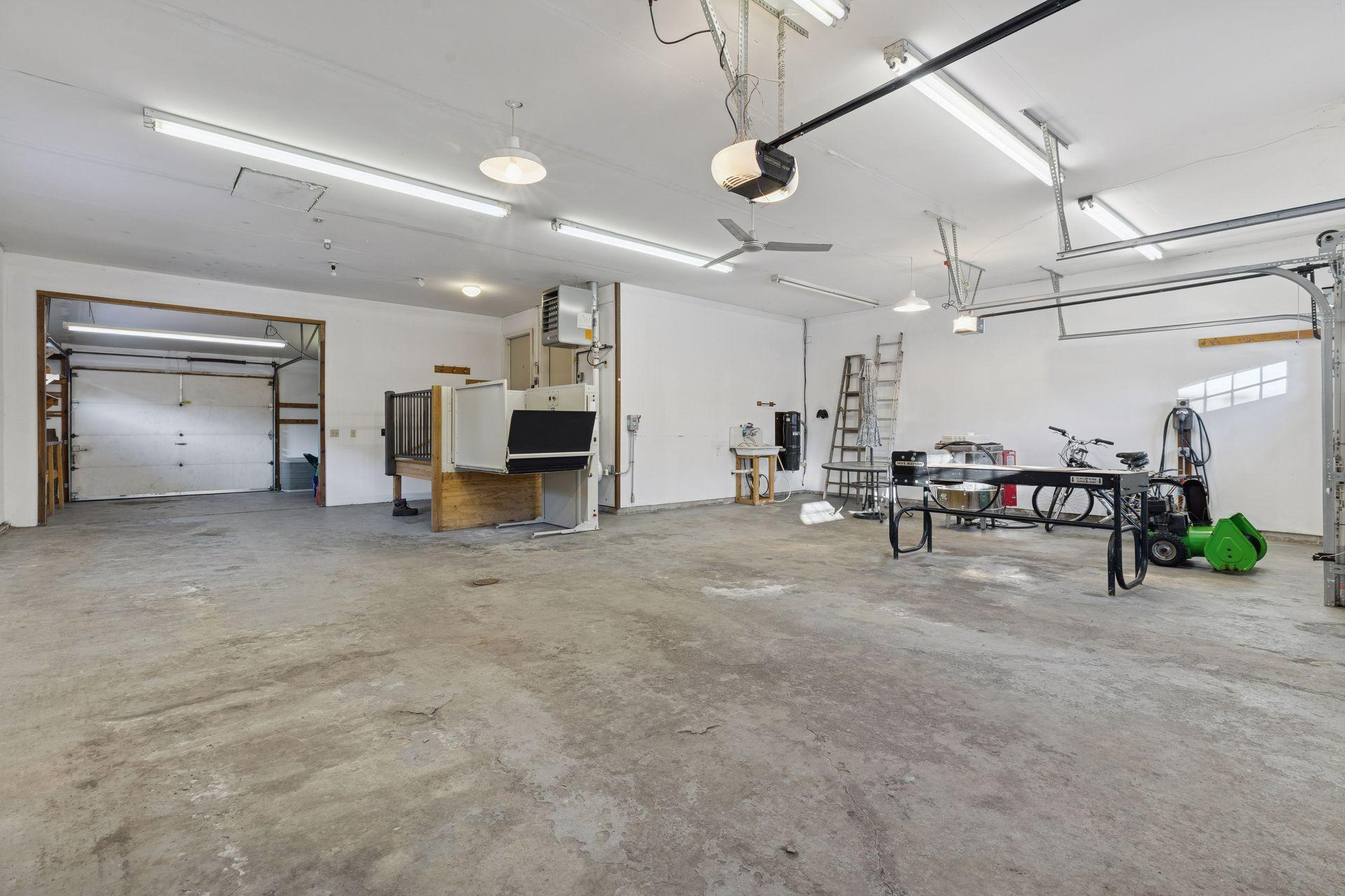 Dream garage - 1,344 square feet - 4+ car! Heated and insulate with floor drain, hot/cold spigots, 30 & 60 amp outlet, EV charger outlet, wheelchair lift, and rear roll-up door.