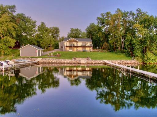 This one of a kind home was built in 2017 and is situated on a 0.67 acre lot with 169 feet of naturally sandy shoreline. The gentle slope to the water is ideal with no steps from the walkout lower level to the dock.