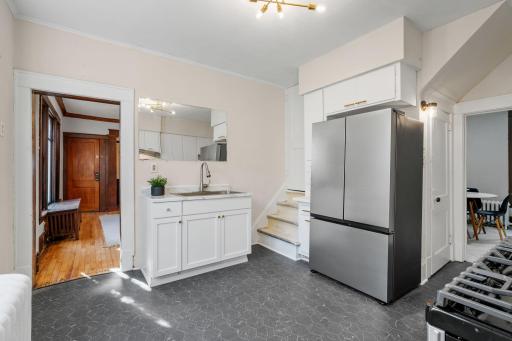 Kitchen with new SS stove, fridge, and flooring.