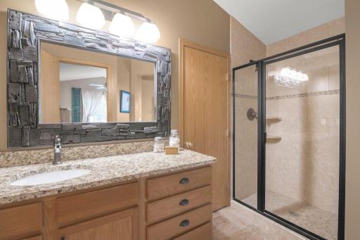 Owner's suite bathroom with walk-in shower. Toilet room next to the shower (right side). Linen closet by the vanity (left side). Owner's walk-in closet between the vanity & shower. Walk-in closet has pass-through to main floor laundry for convenience