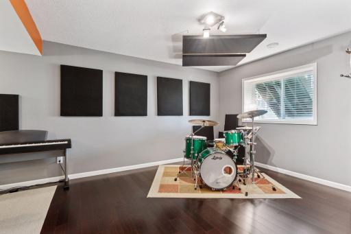 SO COOL! Calling all musicians, or hobbyists, or those in need of a 5th bedroom. This space is well lit and appointed with engineered hardwood flooring and updated decor. The seller plans to take the sound panels, unless buyer wants them.