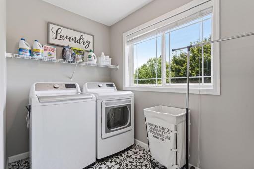 Beautiful laundry room with large window and super cool tile flooring.