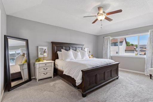 Owner's suite is spacious with tray vault, neutral decor, ceiling fan/light combo and large walk-in closet and luxury bath.