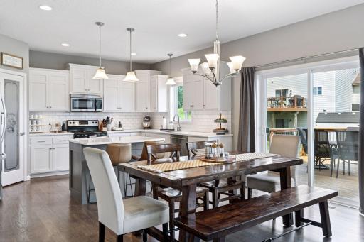 Gorgeous custom kitchen boasts white enameled cabinetry, subway tile backsplash, quartz countertops, undermount sink and large walk-in pantry.