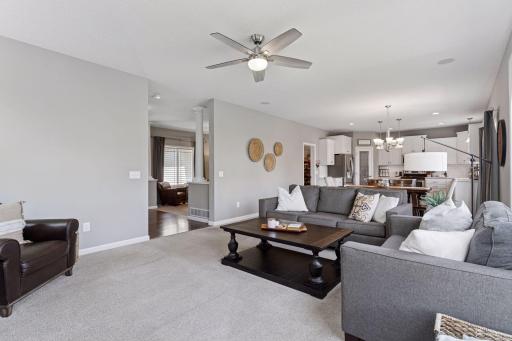 View from family room toward front foyer/living room and kitchen/dining.