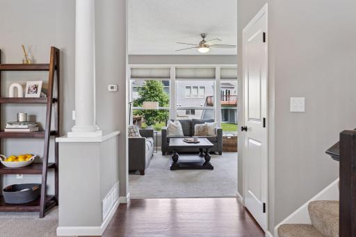 View from foyer toward family room. Note the large windows flooding the space with natural light.