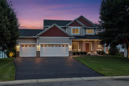 Maintenance free siding with brick accents, pillared front porch and handsome shakes in the gables.