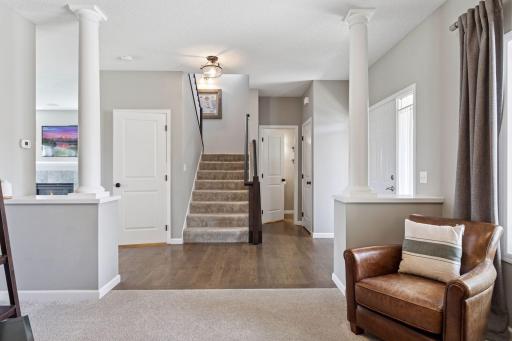 View toward front door, stairway and powder room.